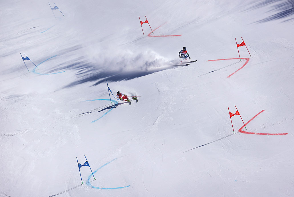 Athletes ski down a slope