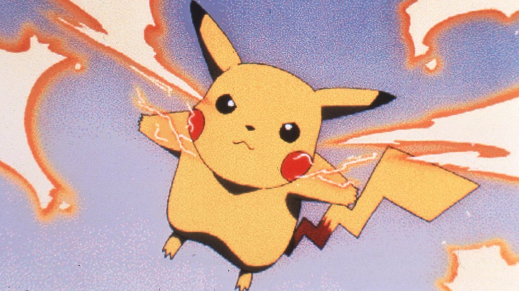 Pikachu leaps into the air. He is yellow with two red cheeks. He is shooting lightning bolts from each cheek.
