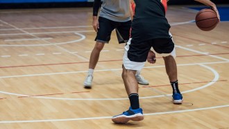 a close up of two players' sneakers on the basketball court, probably squeaking