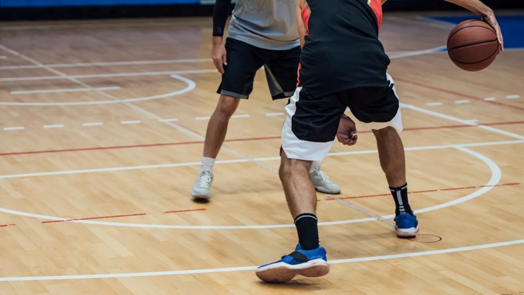 a close up of two players' sneakers on the basketball court, probably squeaking