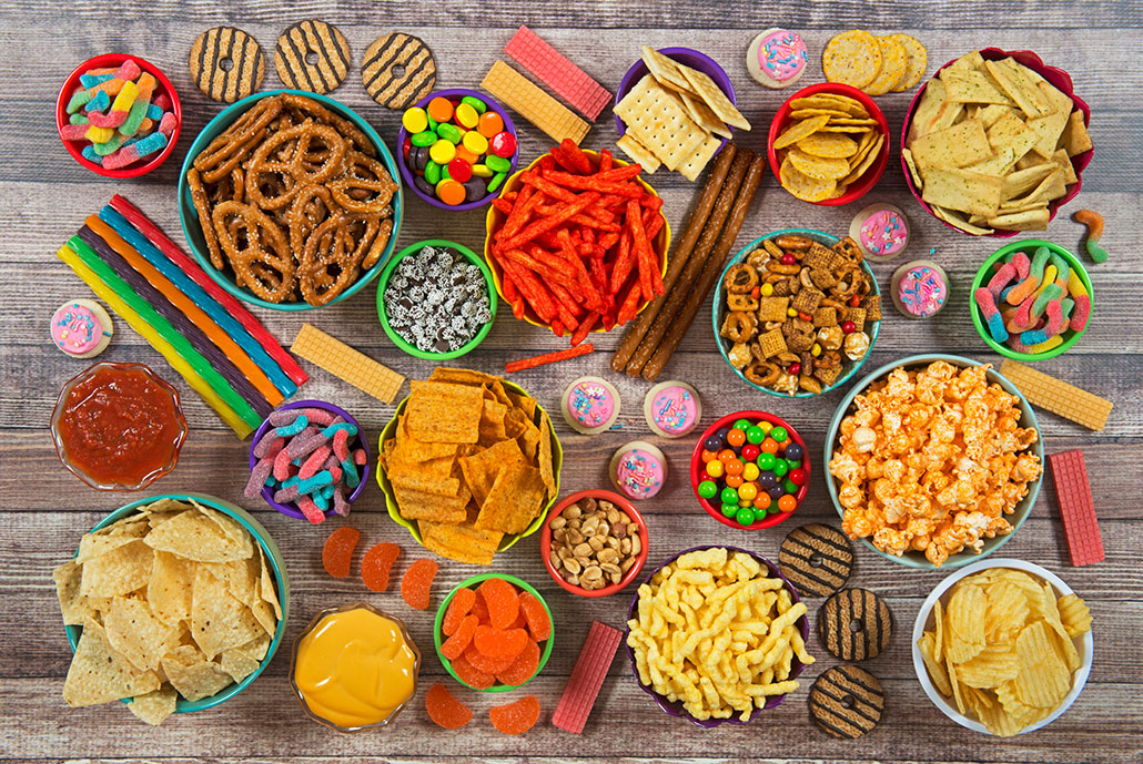 a spread of tasty snacks, candy, chips, and other 'junk' food