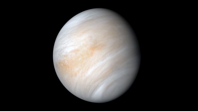 an image of a whitish planet with orange streaks in deep black space