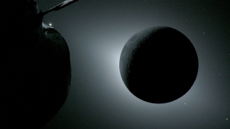 a dark disk with a halo of white light around it in the blackness of space