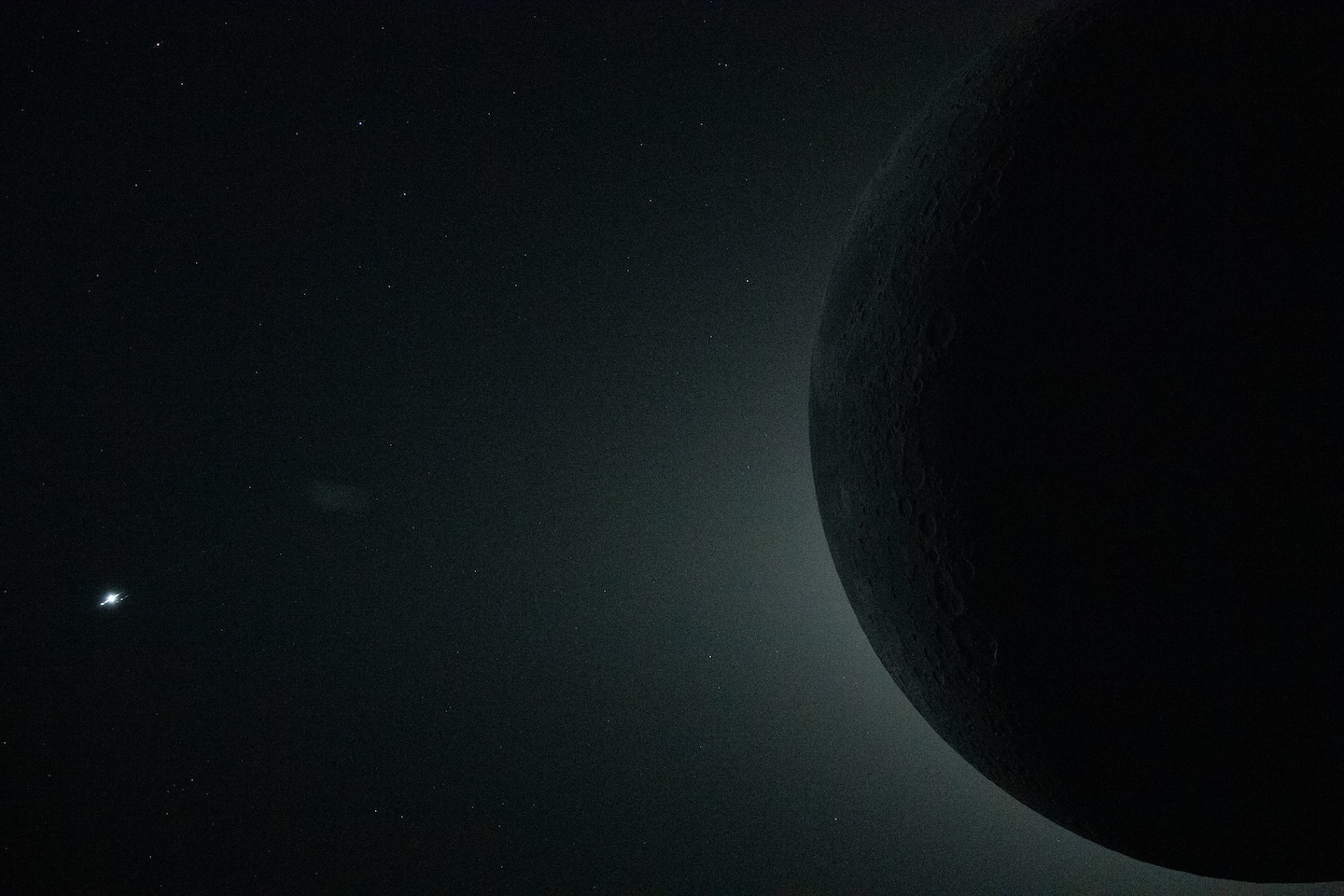 the dark disk of the moon blocks the sun, creating a halo of light behind it