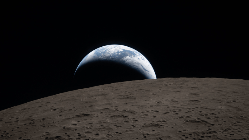 an Artemis II mission photo of the Earth seen rising over the surface of the moon