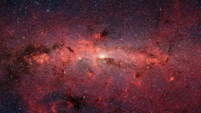 the band of the Milky Way galaxy shown in red light stretches across the sky
