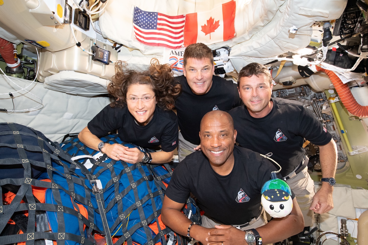 the four Artemis astronauts pose for the camera inside the capsule