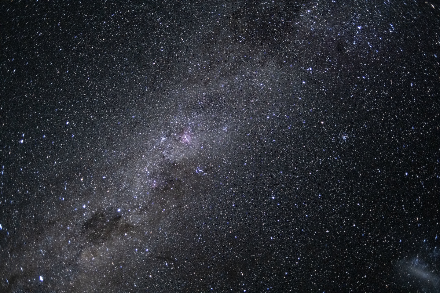 a photo of the night sky with a bright smear of stars across the center