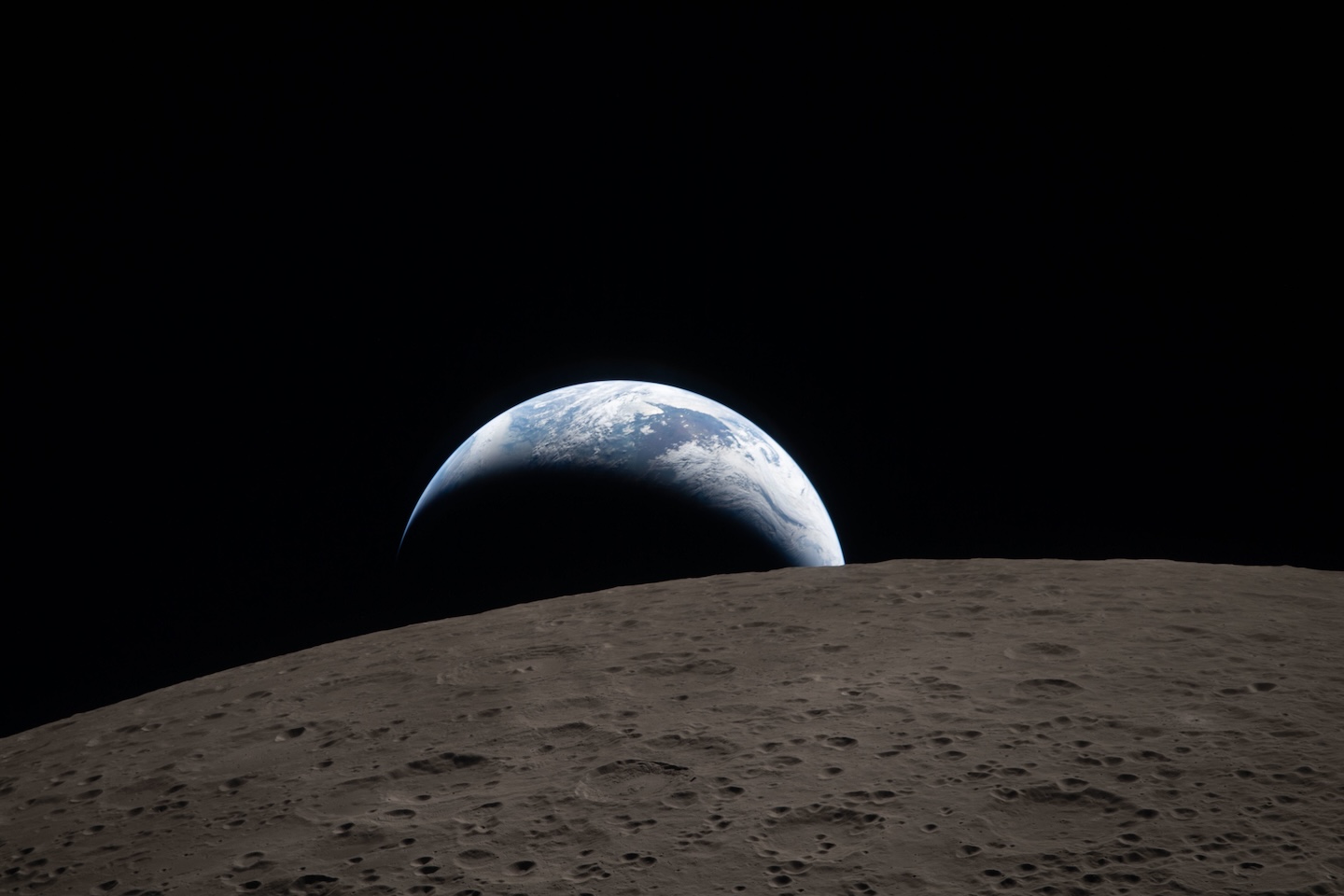 Earth sets behind the horizon of the lunar surface