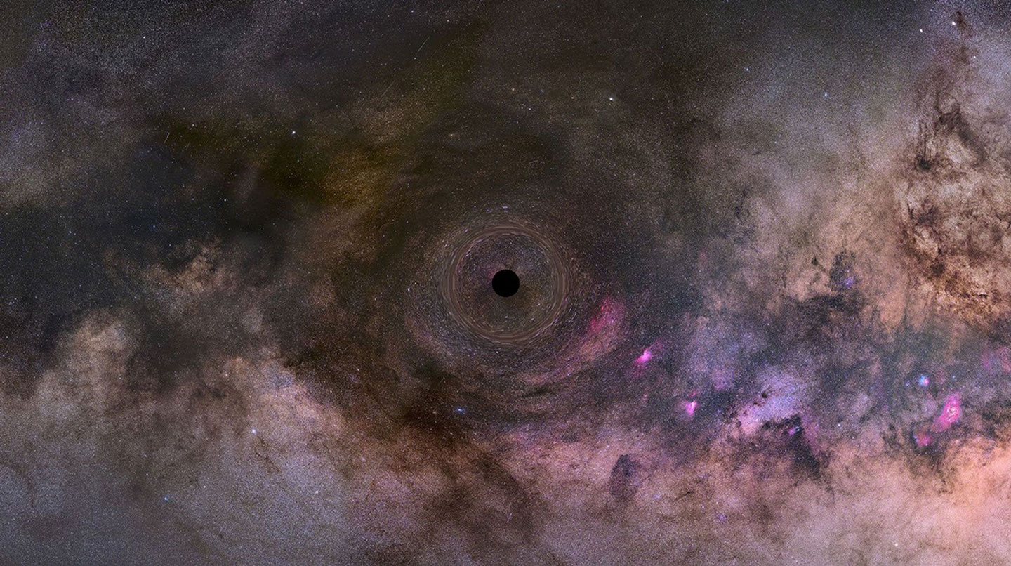 This is an illustration of a close-up look at a black hole drifting through our Milky Way galaxy. The black hole distorts the space around it, which warps images of background stars lined up almost directly behind it.