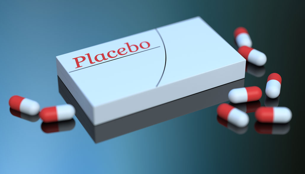 A 3D-rendered illustration of a white pill box labeled 'Placebo' in red lettering, surrounded by red and white capsules on a reflective dark surface.