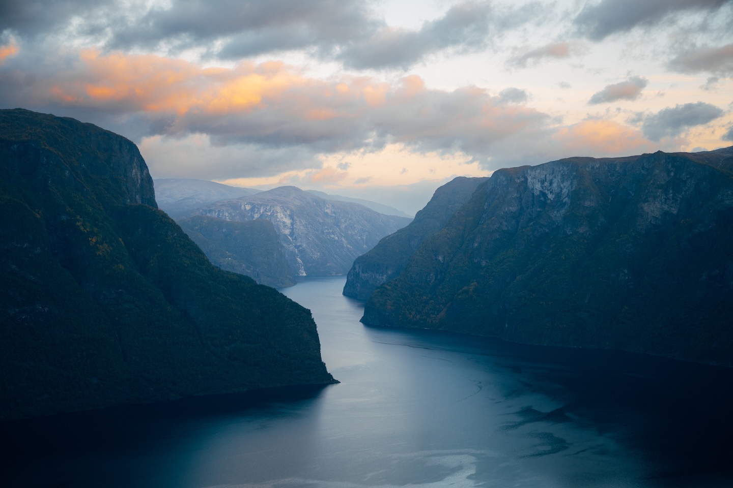 This breathtaking image captures the majestic sunrise over a Norwegian fjord. The warm, golden rays of the rising sun reflect upon the tranquil waters, enveloping the surrounding mountains in a gentle glow. The morning light creates an atmosphere of serenity and tranquil beauty. Perfect for conveying the calming splendor of sunrise, the stillness of the fjord, or evoking a sense of optimism and renewal, this image exudes timeless beauty and the captivating allure of a Norwegian fjord at sunrise.