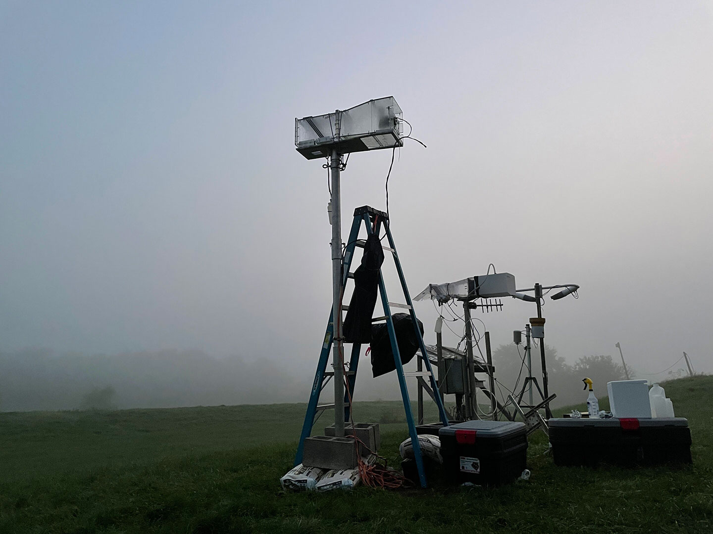 scientific equipment set on grass on during fog