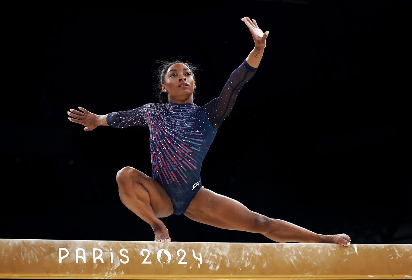 a photo of Simone Biles competing at the Paris 2024 Olympics on the balance beam