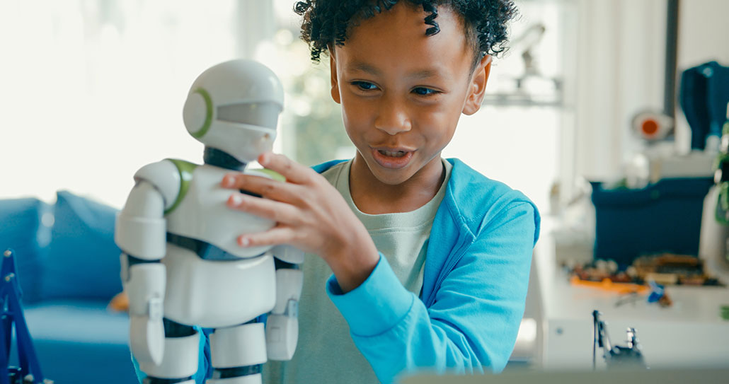 a young kid with dark curly hair and light brown skin plays with a robot toy