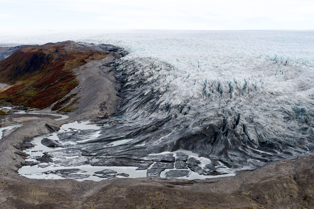 an aerial image of meltwater at the foot of the Greenland Ice Sheet