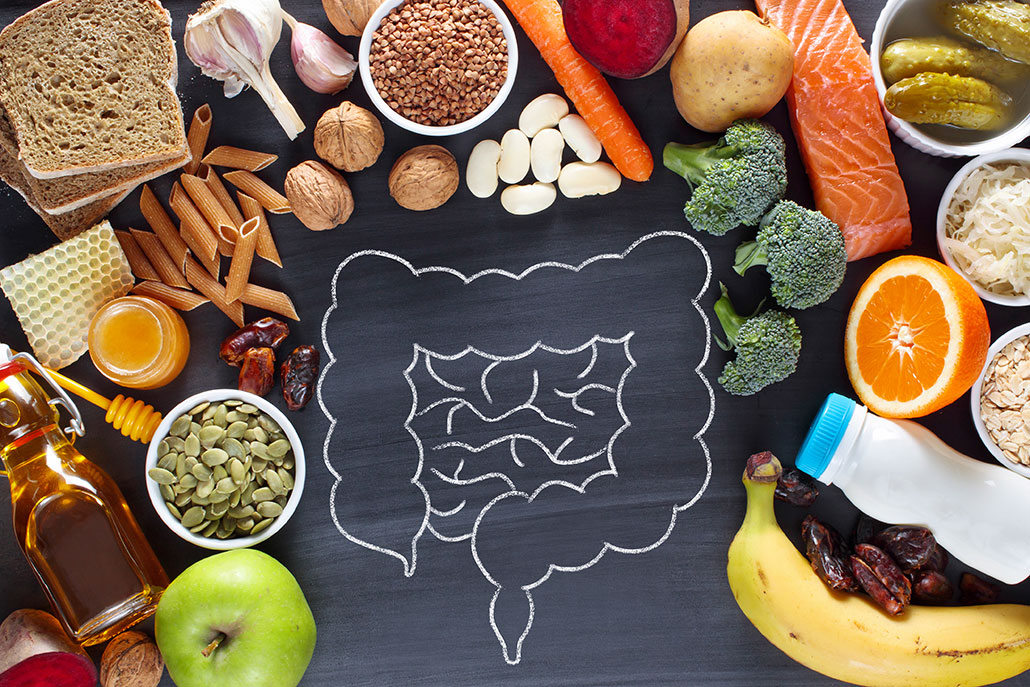a photo looking down at chalk drawing of the human intestines surrounded by various 'healthy' foods