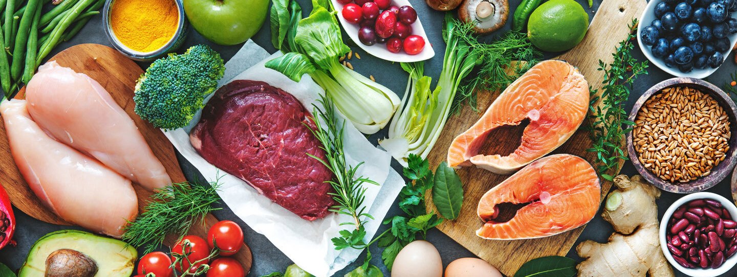a spread of many whole foods, including fruits, vegetables, fish and eggs