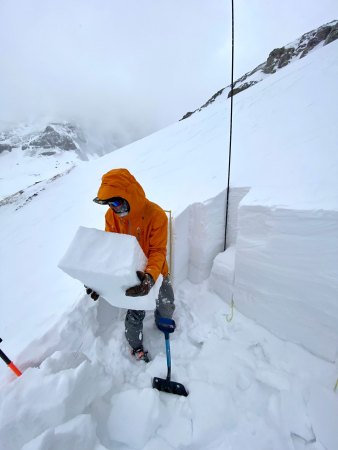 Chris Dickson carries a block of snow.
