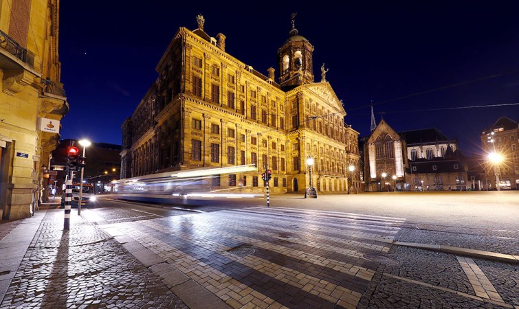 a photo of brick paved roads in Amsterdam at night