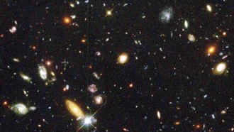 an image of deep space showing hundreds (thousands?) of galaxies