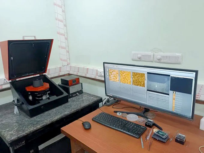 a computer next to some lab equipment